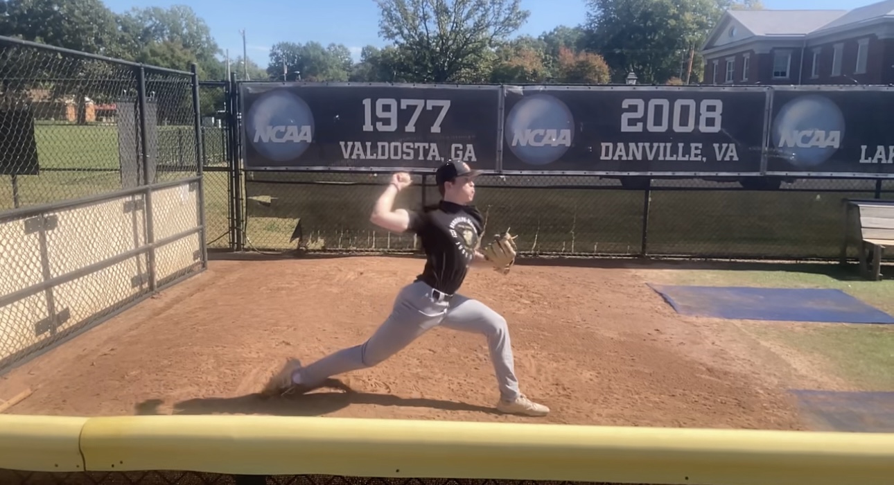 Baseball pitcher in mid-delivery showing the dynamic throwing motion that places high demands on the subscapularis muscle